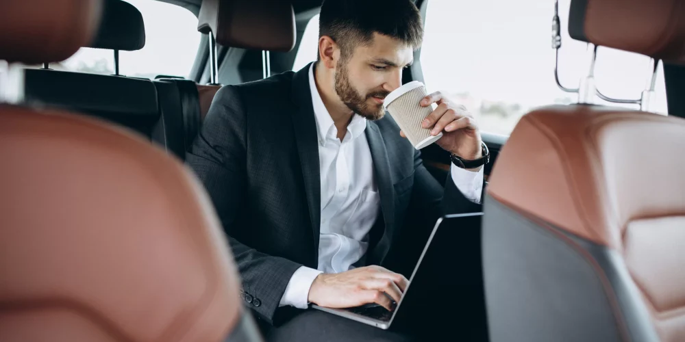 A business man enjoying coffee inside limousine Abu Dhabi