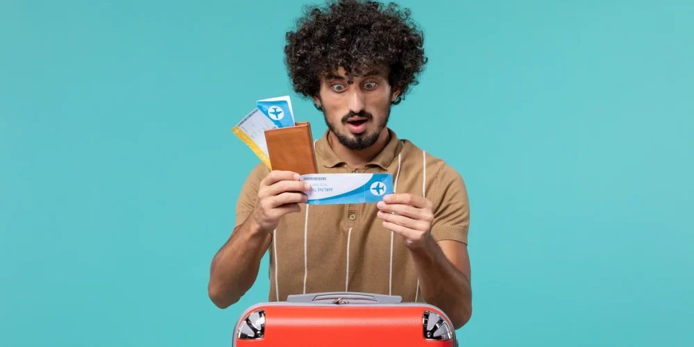 man holding tickets and tourist visa